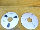 pair of 10.25 inch reel to reel tape spools one with tape , one empty